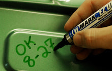 U-Mark EZ OFF marker wiping off metal with a damp cloth
